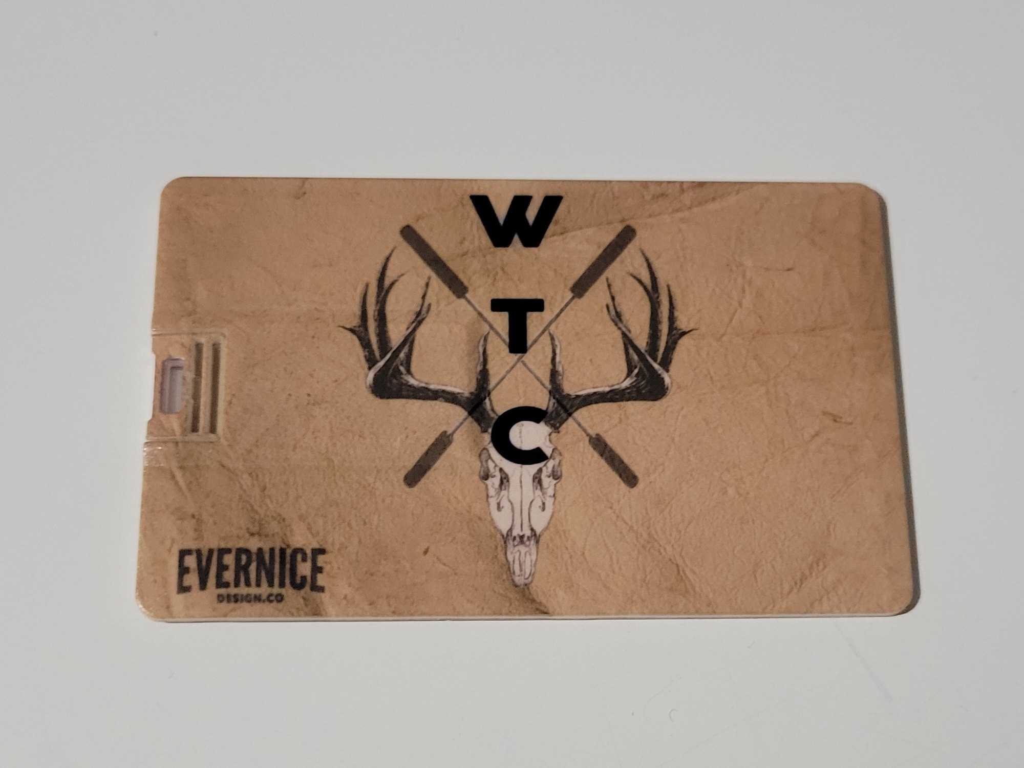 A light tan card with the words EVERNICE Design.Co in the bottom left. In the middle there is an animal skull with big antlers and the letters W T C overlayed vertically